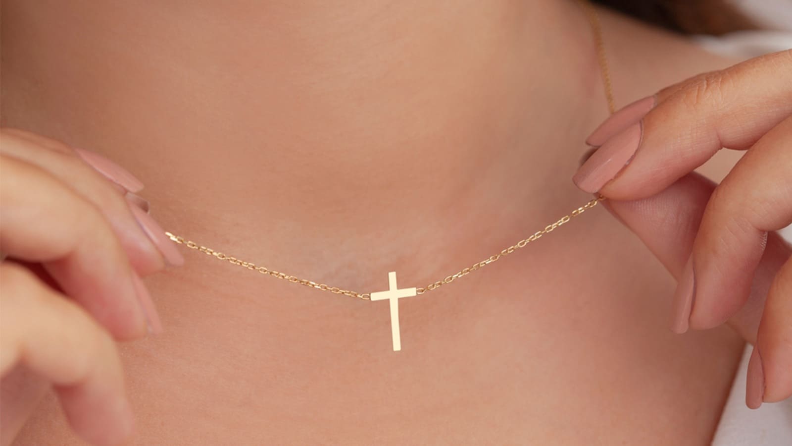 Woman removing cross necklace