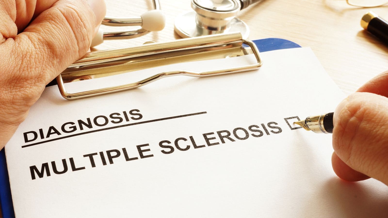 Clipboard with a paper that says diagnosed with multiple sclerosis