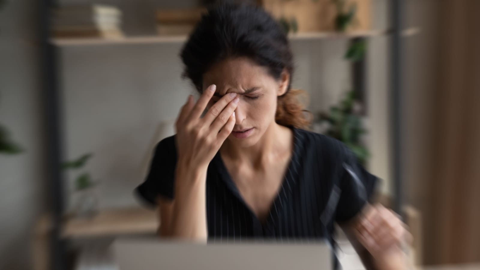 Woman suffering dizziness while working