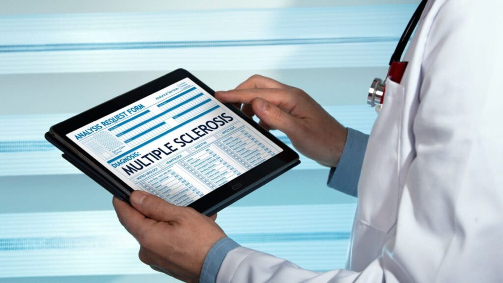 Doctor checking on a tablet with a text of multiple sclerosis