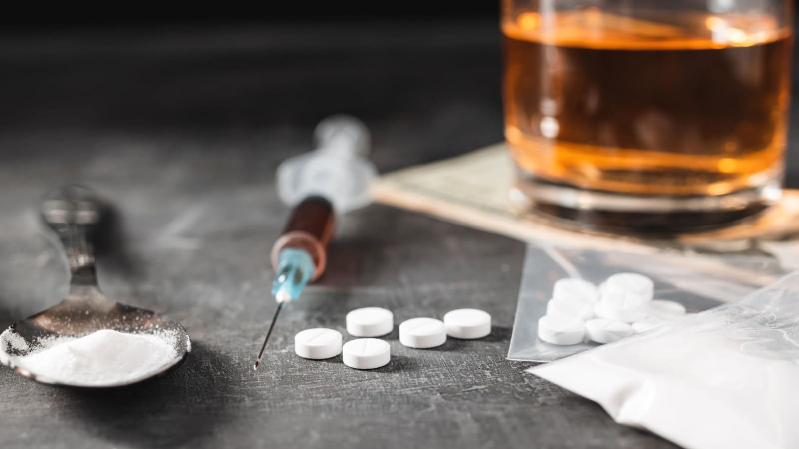 Alcohol and various drugs and a syringe