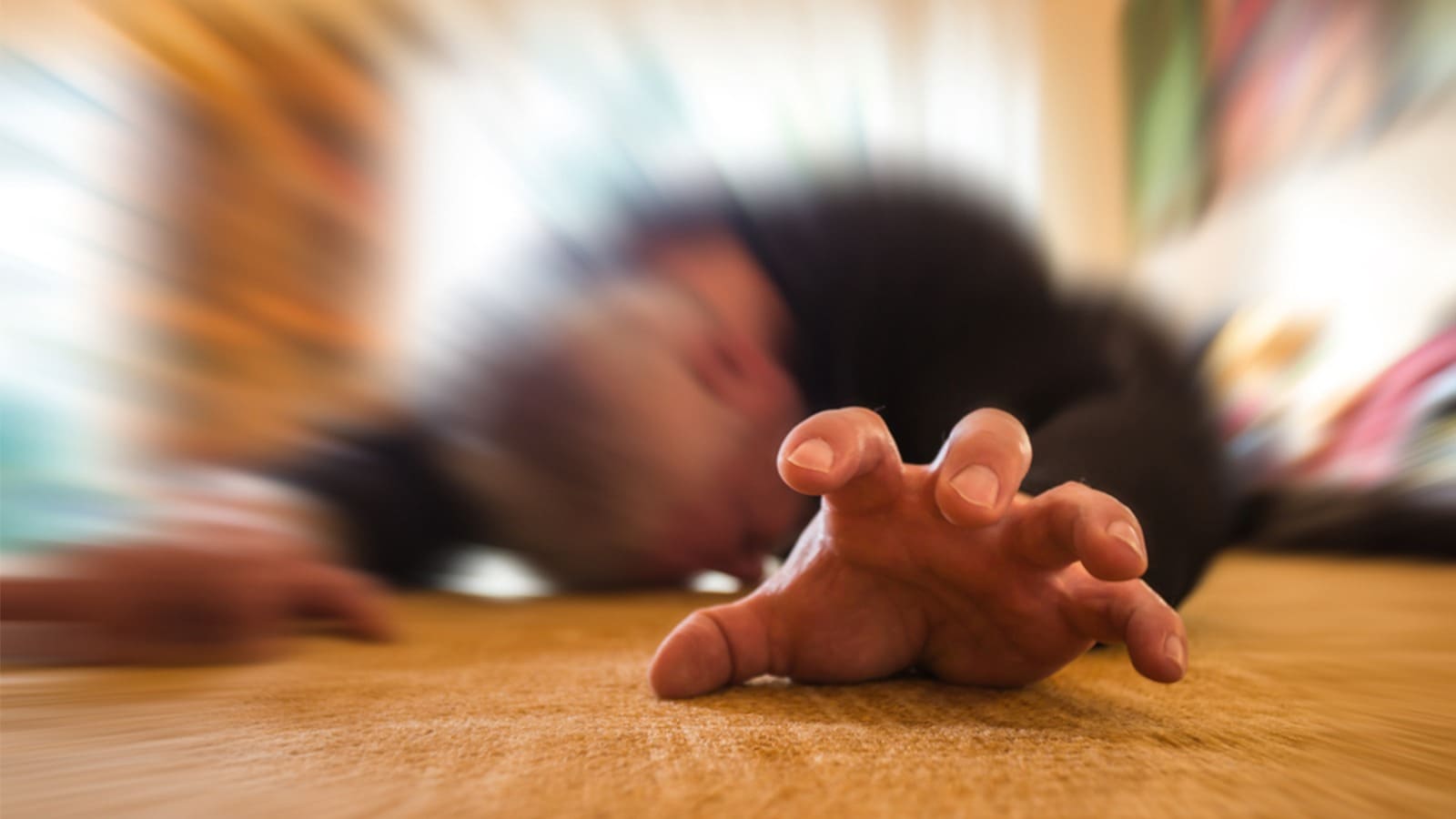 Man lying unconscious on the floor