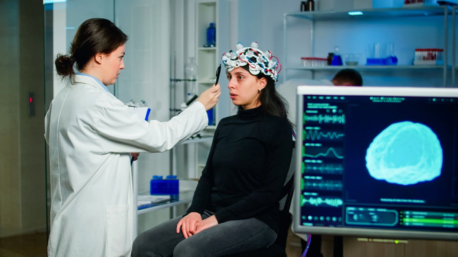 Medical worker preparing a girl patient for an in-office EEG